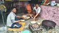 Indian cook making food outside of kitchen.