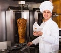 Indian cook offering kebab at counter