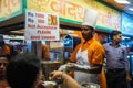 Indian cook preparing street food at the stall in Mumbai at night