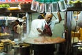 Indian cook preparing street food in the stall in Mumbai at night