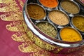 Indian Cookery Spices in Silver Pots on Pink Saree Royalty Free Stock Photo