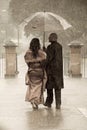 Indian couple holding an umbrella in the rain. Royalty Free Stock Photo