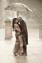 Indian couple kissing under an umbrella in the rain ki Royalty Free Stock Photo