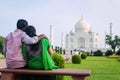 An Indian couple share an intimate moment in front of the monument of love, Taj Mahal