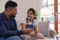 Indian couple shopping online with laptop and credit card from home, sitting on sofa in living room Royalty Free Stock Photo