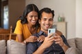 Indian couple using smartphone at home Royalty Free Stock Photo