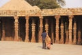 Indian couple walking around Qutub Minar complex, Delhi