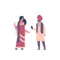 Indian couple wearing national traditional clothes hindu man woman communication concept using smartphone male female Royalty Free Stock Photo