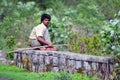 Indian cowboy sitting roadsite