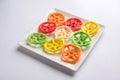 Indian crunchy fryums or papad snack in wheel, square and triangle shapewheel shape colourful fryums papad snack. selective focus