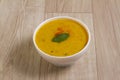 Indian Cuisine Kadhi - Vegetarian Curry Made of Buttermilk And Chick Pea Flour. served in a bowl or Karahi over wooden background