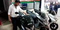 automobile customer touching latest model of motorcycles at bajaj showroom showroom in India aug 2019