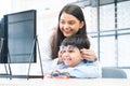 Indian cute child boy trying and choosing new eyeglasses with young optometrist woman or doctor at ophthalmology clinic or optics Royalty Free Stock Photo