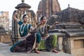 Indian dancer. Two odissi dancers wearing head gear,jewelry and posing in front of Mukteshvara Temple,Bhubaneswar, Odisha.