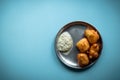 Indian delicious mysore bonda with chutney for a healthy evening snack Royalty Free Stock Photo