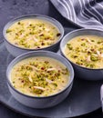 Indian dessert- kesar pista basundi in blue gray pottery Royalty Free Stock Photo