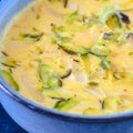 Indian dessert- kesar pista basundi in blue porrwey Royalty Free Stock Photo