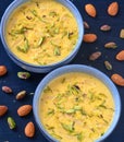 Indian dessert- kesar pista basundi with nuts in background Royalty Free Stock Photo