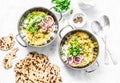 Indian dhal with jasmine rice, marinated red onion, scallion and whole grain flatbread on light background, top view. Flat lay, ve