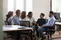 Indian diverse business team employee talking to coworkers