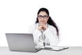 Indian doctor with laptop and clipboard Royalty Free Stock Photo