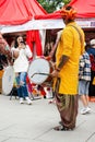 indian drummer playing traditional dhol instrument in the street. Fest day of india in Moscow