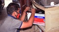 Indian electrician repairing a faulty inverter