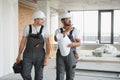 Indian and European construction workers together at a construction site Royalty Free Stock Photo