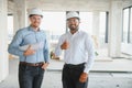 Indian and European construction workers together at a construction site Royalty Free Stock Photo