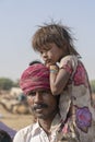 Indian family outdoors in desert on time Pushkar Camel Mela, Rajasthan, India Royalty Free Stock Photo