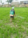 Indian farmer at Field spraying pesticides