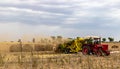 Indian farmer harvesting crop in thrashing machine