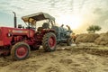 Indian farmer harvesting crop in thrashing machine