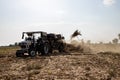 Indian farmer harvesting crop in thrashing machine