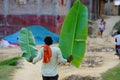 Indian farmer holding leaf of banana in his hand backside image