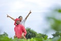 Indian farmer playing with his child at green field