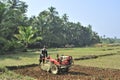 Indian Farmer ploughing field with the help of power tiller