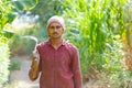 Indian farmer with Sickles in his field