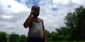An indian farmer talking to mobile phone in the forest area Royalty Free Stock Photo