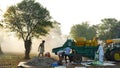 Indian farmer threshing millet or bajra in millet crop using thresher. Technology and agriculture concept