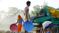 Indian farmer threshing millet or bajra in millet crop using thresher. Technology and agriculture concept