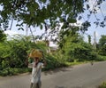 Indian farmer walking on road