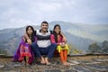 Indian father sitting with his daughters and smiling, happy family concept Royalty Free Stock Photo