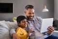 Father and son using digital tablet to make a video call