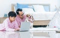 Indian father, son using laptop, doing homework, watching movie and playing together with dog in cozy or comfortable living, Royalty Free Stock Photo