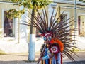 Indian with feathers on his head plays the flute. Russia. Saint-Peterburg. Autumn 2017.
