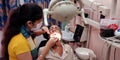 An indian female dentist treating oral infection at dental clinic