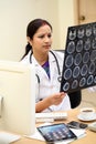 Indian female doctor examing MRI scan report Royalty Free Stock Photo