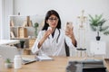 Indian female doctor having video call on smartphone