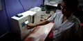An indian female nurse staff adjusting machine frequency